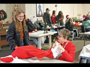 Press photo/Jake Browning - Lauren Macumber presents Leanne Webb with her Christmas stocking at Macon Citizens Habilities.