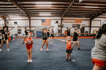 Photo/Alyssa Burk - Ruby Red cheerleaders practice a routine inside New Vision Training Center in Franklin. 
