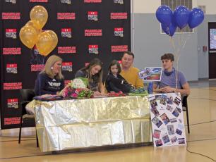 Press Photo/Will Woolever - FHS track and field standout Anna Tastinger signs her official offer from Montreat College as her mom, Julie; sister, Matilda; dad, John; and brother, John II look on.