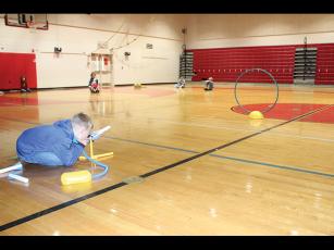 East Franklin Elementary School third grader Levi Johnson learns a lesson on trajectory by firing an air-propelled rocket through a hoop.