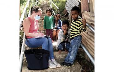 Franklin native Molly Hornsby visits with a family in the Los Pinos neighborhood in Honduras.