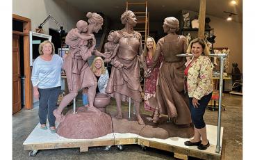 Photo submitted The leadership team for the Women’s History Trail project of the Folk Heritage Association of Macon County recently visited Wesley Wofford’s studio in Cashiers. Wofford is creating the “Sowing the Seeds of the Future” statue that will be installed in Franklin. Pictured is the clay version of the statue; molds will be made to produce the final bronze statue. Pictured are (from left) Anne Hyder, chair of the Folk Heritage Association of Macon County; Theresa Ramsey, treasurer of the Folk Herit