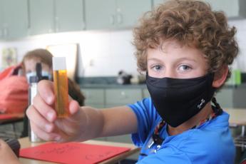 Press photo/Jake Browning - Fifth grader Cam English holds up a case of mechanical pencil graphite. English was surprised to learn how similar a vape pen can look to this common school supply, but anti-smoking advocates say that’s an intentional design choice meant to facilitate vaping for younger consumers.