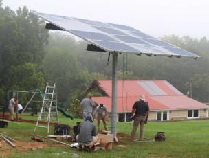 Press photo/Jake Browning - Work crews install a solar panel at Mountain View Intermediate as part of the Solar + Schools program.