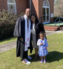 Pastor D’Andre Ash with his wife and daughter.