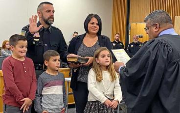 Press photo/Rachel Hoskins - Brent Holbrooks is joined by his wife, Sarah, and children Knox, Tripp and Saylor, as Chief District Court Judge Roy Wijewickrama administers the oath of office to the newly elected sheriff of Macon County.