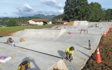 Press photo/Will Woolever - Workers are putting the finishing touches on the new skatepark on First Street in Franklin. The town hopes to have a ribbon cutting for the park in September.