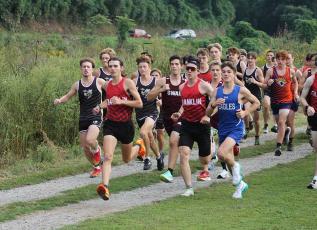 Press photo/Will Woolever - Senior Logan Russo (left, foreground) leads the pack off the line at Kituwah Sept. 16. 