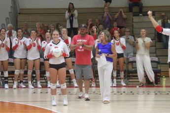 Press photo/Will Woolever - Senior setter McCall Sanders (left) gets a standing ovation from fans for her 1,000th career assist on Tom Raby Court Sept. 26.