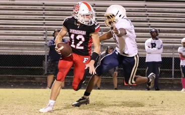 Freshman quarterback Anderson Terrell evades a defender in Franklin’s 35-26 win over T.C. Roberson Oct. 26. (Photo courtesy of Ronnie Vanhook)