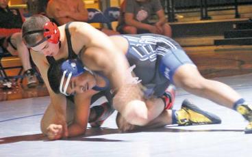 Press photo/Will Woolever - Freshman Carson Smith battles a wrestler from Smoky Mountain in the 157-lb. weight class Dec. 12.
