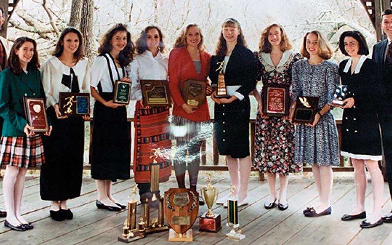 Photo submitted - The 1992 girls cross country team proudly displayed their plaques and trophies garnered during their state-championship winning season. From left: assistant coach Steve Philo, Amy Berger, Stephanie Hyder, Kristy Henson, Nikki Pons, Corie Fuchs, Marla Getford, Erica Riendeau, Jennifer Wiggins, Jessa Brown, head coach David Morgan. Not pictured: Emily Beller, Derrah Ledford.