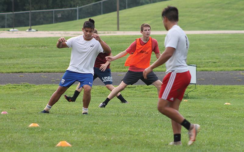 Press photo/Will Woolever - FHS soccer players (from left) Pablo Montelongo, Luke VanHook and Bryan Rodriguez take part in a preseason conditioning drill. The team has been holding unofficial workouts since June.