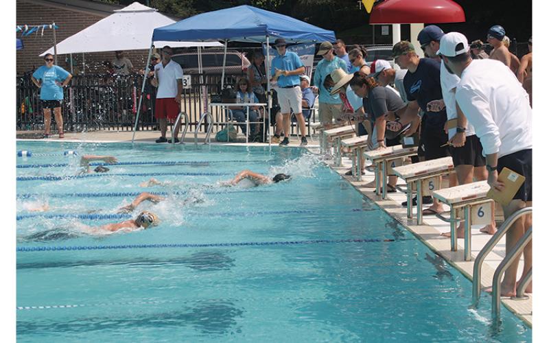 Press photo/Will Woolever - Timers watch a close finish in the boys’ 11-12 100-yard freestyle at the Mountain Swim League All-Star Meet July 24.
