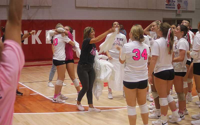Press photo/Will Woolever - Head coach Bekah Brooks passes out “2023 Conference Champion” T-shirts to her team following their title-clinching home win over West Henderson Oct. 5. 