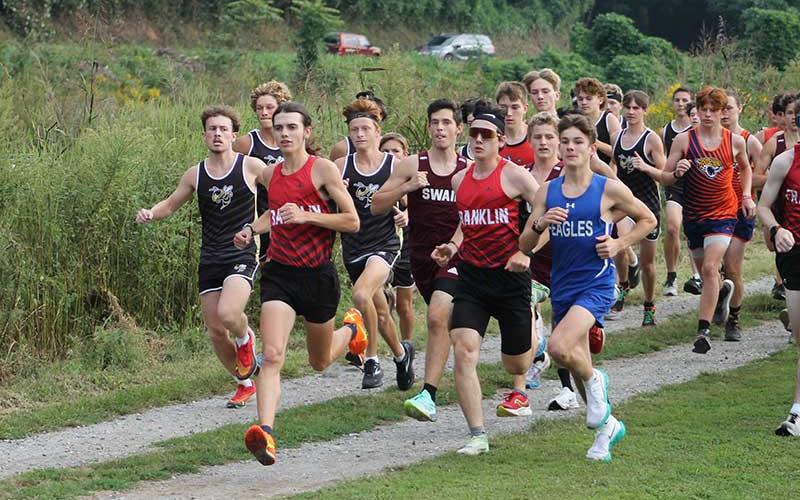 Press photo/Will Woolever - Senior Logan Russo (left, foreground) leads the pack off the line at Kituwah Sept. 16. 