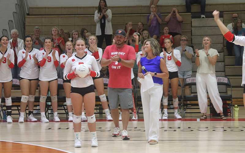 Press photo/Will Woolever - Senior setter McCall Sanders (left) gets a standing ovation from fans for her 1,000th career assist on Tom Raby Court Sept. 26.