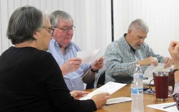 Press photo/Thomas Sherrill - Macon County Board of Elections Chair Kathy Tinsley, Vice Chair Gary Dills and Secretary Jeffrey Gillette look over provisional votes during canvass on Friday, March 15.